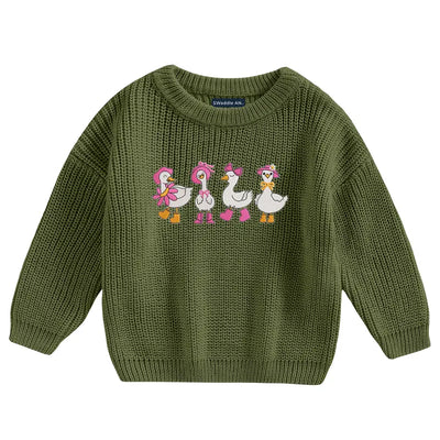 Green knitted sweater with embroidered ducks on a white background