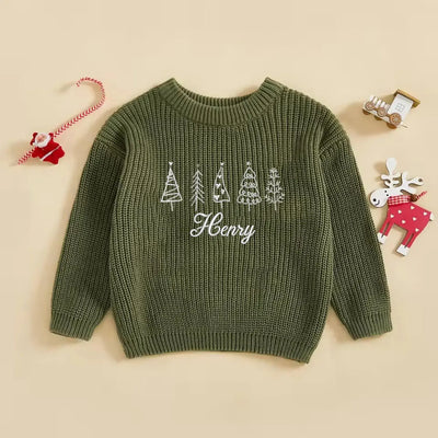 Green sweater with embroidered trees and 'Henry' on a beige background