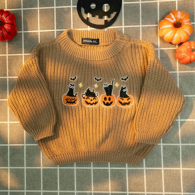 Children's sweater with Halloween design on a tiled floor