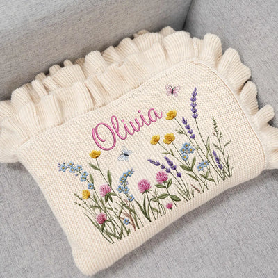 Embroidered blankets with floral designs and the name 'Olivia'