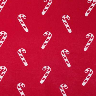 Pattern of white candy canes on a red background