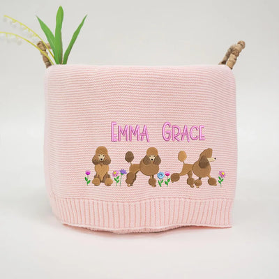 Pink personalized baby blanket with embroidered poodles and 'Emma Grace' text on a white background